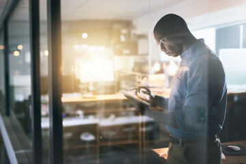 Canvas Print - Black man in business, tablet and night at office, information technology and software update. Male programmer work late, overtime and deadline with focus, concentration and cyber security upgrade