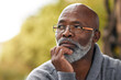 © Katleho Seisa/peopleimages.com - Senior man, face and thinking outdoor in nature to remember memory, idea or vision. Headshot of an elderly African male person think or planning future, life insurance or retirement at a park