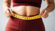 © rorozoa - Young woman with slim body measuring her waist. Weight loss, healthy lifestyle concept. Generative Ai