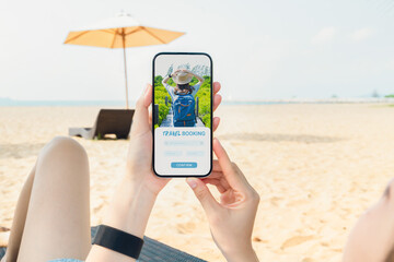 Wall Mural - Woman sitting on deckchair on the beach using smartphone with application booking flight travel search ticket holiday and hotel on website, concept technology online marketing and promotion.