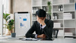© laddawan - Asian businessman is stressed, bored, and overthinking from working on a tablet at the office.