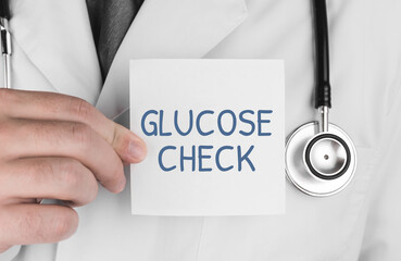 Wall Mural - Doctor holding a sticker with word Glucose Check, Medical concept