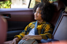 Smiling Girl Sitting On Backseat In Car