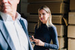 © Westend61 - Blond businesswoman holding smart phone in factory