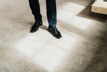 Businessman Wearing Shiny Formal Shoes Standing On Floor In Factory
