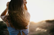 © Westend61 - Woman with long hair at sunset