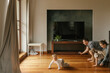 © Westend61 - Playful family crawling on hardwood floor at home