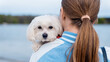 Blonde woman holding maltese dog