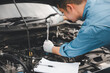 © sorapop - Service outdoor. Asian auto mechanic man working on car engine using wrench to repair and maintenance, broken car care check and fixed the problem and services insurance