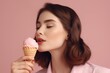 Close-up portrait attractive woman licking favorite ice cream on pink pastel background. Ai generative.