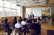 © Studio Romantic - Businessman giving report or presentation to business colleagues. Professional coach consulting, training, explaining strategy to interested people, giving educational workshop in conference room