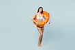 Full body fun young woman wear swimsuit stand in lifeguard inflatable ring stand akimbo look camera near hotel pool isolated on plain pastel blue background. Summer vacation sea rest sun tan concept.