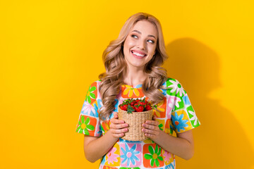 Sticker - Portrait of gorgeous woman wavy hairdo wear flower print t-shirt holding strawberry look empty space isolated on yellow color background