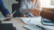 © Ratirath - Shaking hands, Business lawyer team. Working together judge counselor having team meeting with client discussing legal legislation at law firm, Law and Legal services concept.