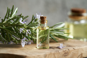 Wall Mural - A bottle of rosemary essential oil on a table