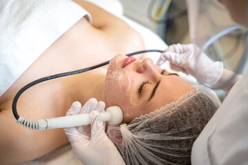 Wall Mural - Beautiful young woman having Radio frequency skin tightening treatment in beauty clinic