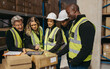 © Jacob Lund - Cheerful warehouse team looking at a statistical report on a digital tablet