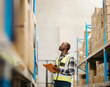 © Jacob Lund - Young logistics worker taking stock in a modern warehouse
