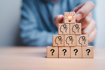 Poster - businessman stacking glowing lightbulb icon on top of human thinking and question for creative idea 