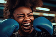 Happy Black Female Boxer: Close-up portrait of a laughing African American woman wearing blue boxing gloves and a leather jacket. Generative AI