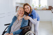 © Halfpoint - Portrait of nurse and her senior client on wheelchair.