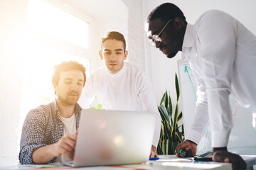 Sticker - Group of focused diverse colleagues working on project in office