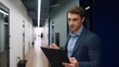 © stockbusters - Happy worker checking papers on clipboard. Office mentor making notes walking