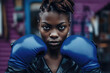 Close-Up of Female Boxer:  A close-up of a young, dark-skinned female boxer with a serious expression, posing on the street with blue boxing gloves and looking directly into the camera. Generative AI