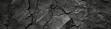 Fototapeta Desenie - Volumetric rock texture with cracks. Black stone background with copy space for design. Wide banner