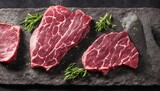 Fototapeta  - Raw steak on a slate. Two raw steaks on a dark shale background. generative ai. Slice of meat with salt, pepper and herbs