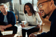 © Flamingo Images - Young African American businessman talking with colleagues during a meeting