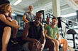 © Flamingo Images - Diverse people laughing on steps in a gym