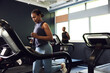 © Flamingo Images - Woman running on a treadmill in a gym
