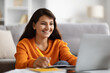 © Prostock-studio - Positive young indian woman student attending webinar, using laptop