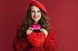 happy elegant woman in red sweater and beret with red heart