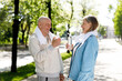 © sakoqwakestock - Mature Couple Are Carrying Towels Around Their Necks Talking and Holding a Bottle of Water After Running. Mature Couple Communicating and Drinking Water After Jogging. Communicating and Love Concept