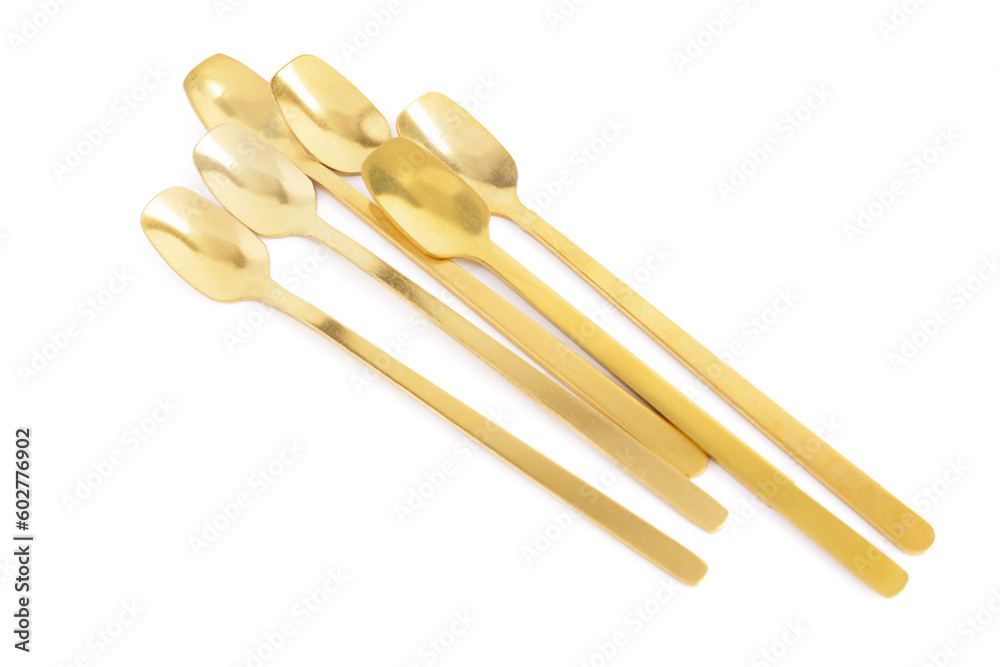 Golden spoons on white background