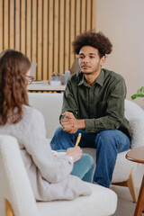 young man in consultation with psychologist is taking care of mental health. Psychotherapy for treatment of disorders and depression, insomnia. African American guy tells doctor about his problems