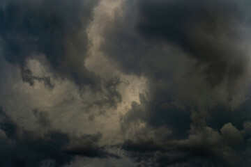 Wall Mural - dramatic stormy sky with fluffy dark cumulus clouds