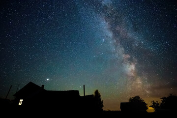Wall Mural - night starry sky and milky way above countryside