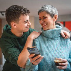 teenager boy young man and mature woman mother and son take selfie photos self portraits at home