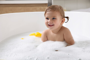 Canvas Print - Cute little girl taking foamy bath at home