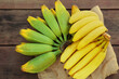 © New Africa - Different sorts of bananas on wooden table, flat lay