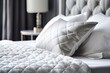 Soft white quilted cushion in bed with white leather headboard in the backdrop. Clean pillow, comfort, close up of a bed component. Background with quilted headboard and mockup design Generative AI
