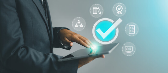 Fototapete - Businessman working on computer laptop. correct sign tick mark with business icon on the virtual screen for online approve paperless and quality assurance concept. Technology and business concept.