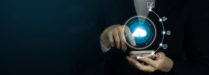 Fototapete - Businesswoman using smartphone connecting cloud storage big data online digital by finger touching on mobile phone. Black background. Technology concept