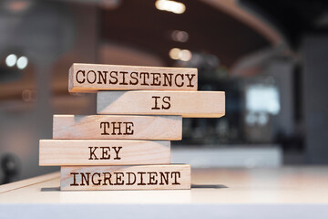 Wall Mural - Wooden blocks with words 'Consistency is the key ingredient'.