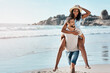 © Chanelle Malambo/peopleimages.com - Nature, beach and piggy back, happy couple with mockup and waves with blue sky, summer holiday and travel to ocean. Love, man and woman playful on sand, happiness and vacation time together in Mexico