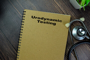 Wall Mural - Concept of Urodynamic Testing write on book with stethoscope isolated on Wooden Table.