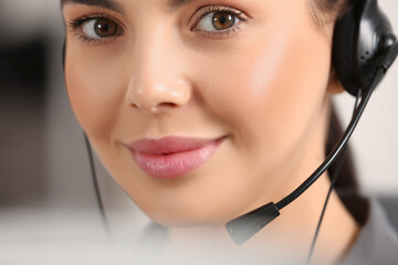 Wall Mural - Hotline operator with headset working in office, closeup